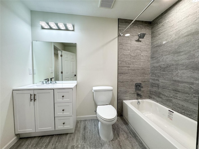bathroom featuring wood finished floors, toilet, baseboards, and bathtub / shower combination