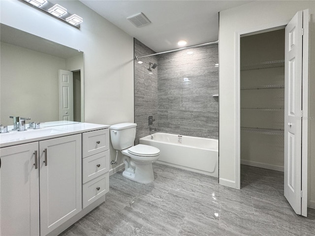 bathroom featuring toilet, vanity, shower / tub combination, and baseboards