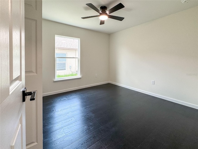 spare room featuring ceiling fan, baseboards, and dark wood-style flooring