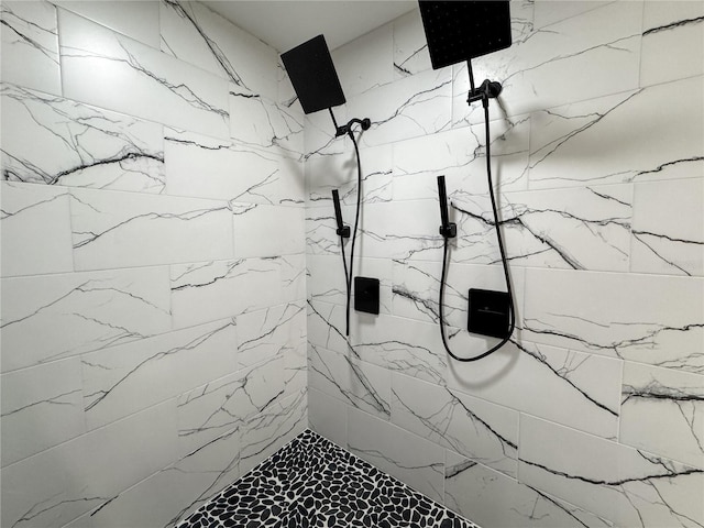 bathroom with a marble finish shower and marble finish floors