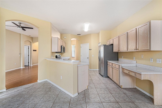 1744 Brookstone Way, Plant City, FL 33566 - kitchen with stainless steel appliances, arched walkways, and light tile patterned floors
