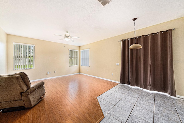 1744 Brookstone Way, Plant City, FL 33566 - unfurnished living room featuring ceiling fan, a textured ceiling, and wood finished floors