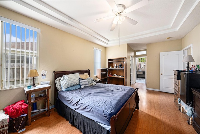 1744 Brookstone Way, Plant City, FL 33566 - bedroom featuring a raised ceiling, wood finished floors, and a ceiling fan