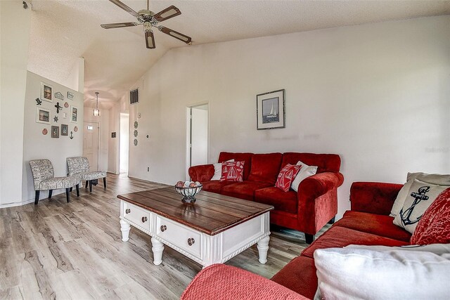 8913 Welsh Way, Hudson, FL 34667 - living room with ceiling fan, lofted ceiling, wood finished floors, and a textured ceiling