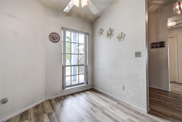 8913 Welsh Way, Hudson, FL 34667 - spare room with wood finished floors, ceiling fan, baseboards, and vaulted ceiling