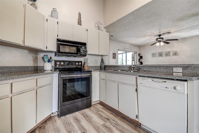8913 Welsh Way, Hudson, FL 34667 - kitchen featuring white dishwasher, black microwave, stainless steel electric range oven, a sink, and a textured ceiling