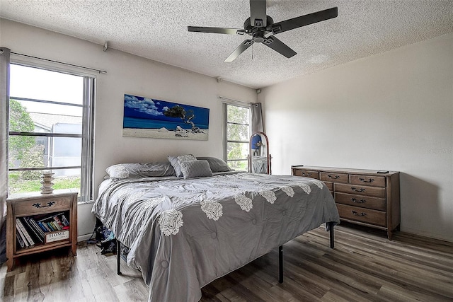 8913 Welsh Way, Hudson, FL 34667 - bedroom with a textured ceiling, wood finished floors, and ceiling fan