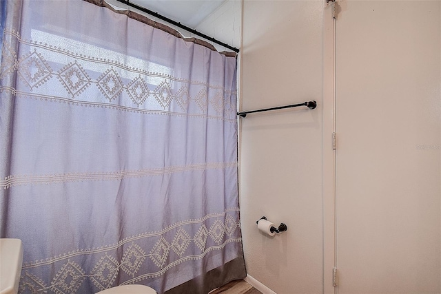 8913 Welsh Way, Hudson, FL 34667 - bathroom featuring a shower with shower curtain and wood finished floors