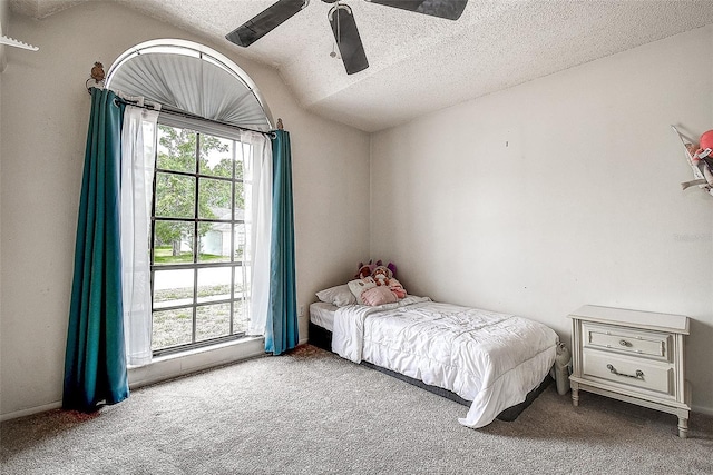 8913 Welsh Way, Hudson, FL 34667 - carpeted bedroom featuring a textured ceiling, vaulted ceiling, and ceiling fan