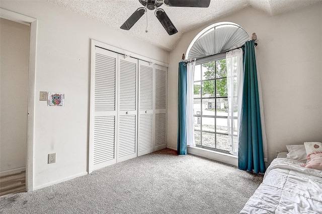8913 Welsh Way, Hudson, FL 34667 - carpeted bedroom featuring a textured ceiling, vaulted ceiling, a closet, and ceiling fan