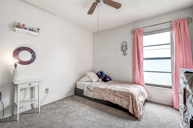 8913 Welsh Way, Hudson, FL 34667 - bedroom with multiple windows, a textured ceiling, carpet, and a ceiling fan