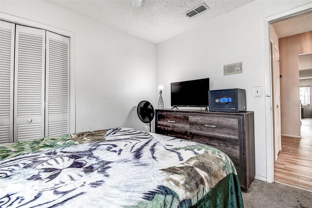 8913 Welsh Way, Hudson, FL 34667 - carpeted bedroom with a textured ceiling and a closet