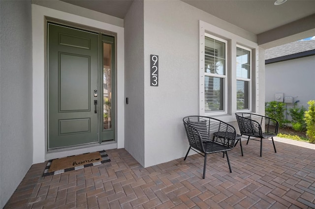 923 Whimbrel Run, Bradenton, FL 34212 - view of exterior entry with stucco siding and covered porch