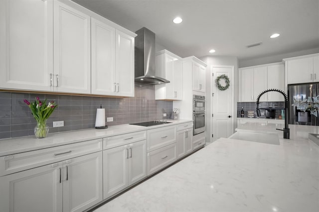 923 Whimbrel Run, Bradenton, FL 34212 - kitchen with wall chimney range hood, a sink, stainless steel appliances, white cabinets, and recessed lighting