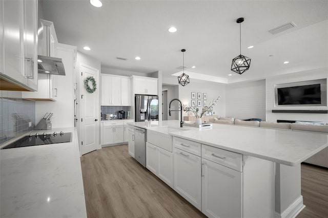 923 Whimbrel Run, Bradenton, FL 34212 - kitchen with appliances with stainless steel finishes, recessed lighting, a sink, open floor plan, and light wood finished floors