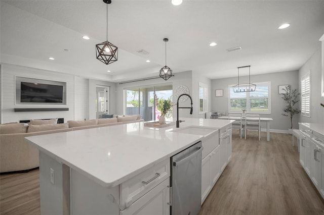 923 Whimbrel Run, Bradenton, FL 34212 - kitchen with a sink, dishwasher, wood finished floors, recessed lighting, and white cabinets