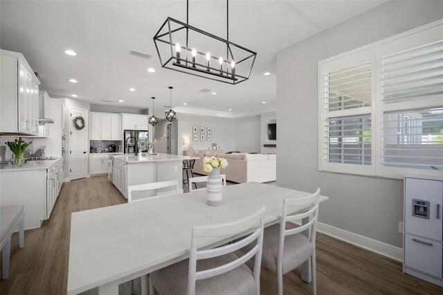 923 Whimbrel Run, Bradenton, FL 34212 - dining room with light wood-type flooring, a chandelier, recessed lighting, and baseboards