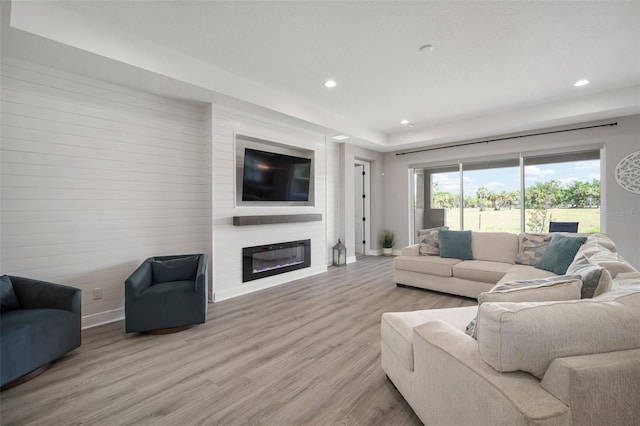 923 Whimbrel Run, Bradenton, FL 34212 - living area with a fireplace, baseboards, wood finished floors, and recessed lighting