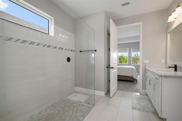 923 Whimbrel Run, Bradenton, FL 34212 - bathroom featuring a tile shower, plenty of natural light, connected bathroom, and vanity