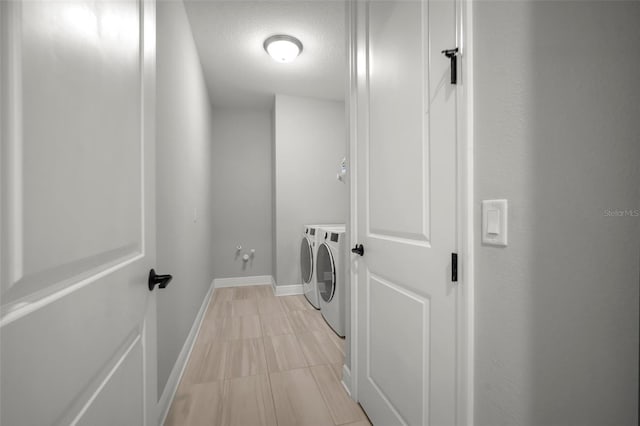 923 Whimbrel Run, Bradenton, FL 34212 - clothes washing area featuring separate washer and dryer, baseboards, a textured ceiling, and light tile patterned flooring