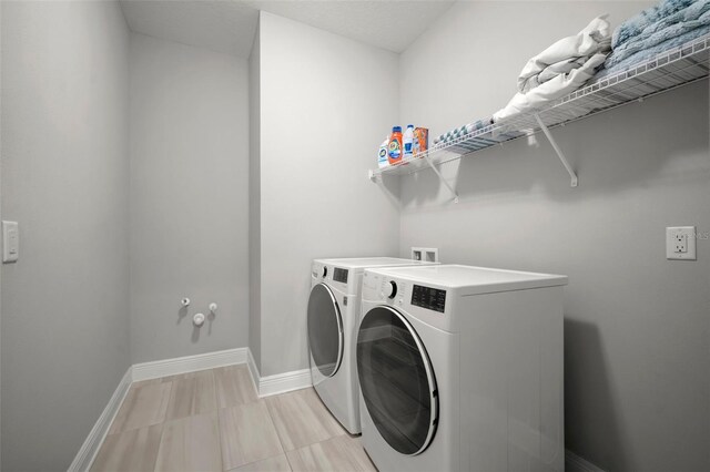 923 Whimbrel Run, Bradenton, FL 34212 - laundry area featuring washer and clothes dryer and baseboards