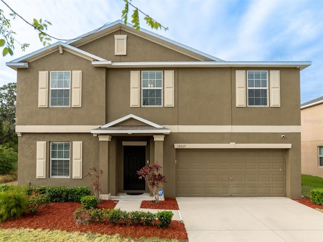 12607 Flatwood Creek Dr, Gibsonton, FL 33534 - view of front facade featuring stucco siding, concrete driveway, and an attached garage