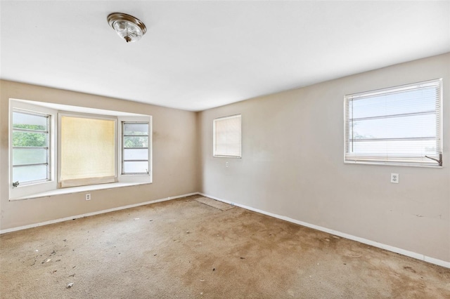 1810 Maryland Ave NE, Saint Petersburg, FL 33703 - carpeted empty room featuring plenty of natural light and baseboards