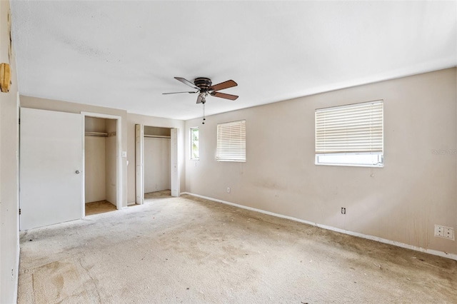 1810 Maryland Ave NE, Saint Petersburg, FL 33703 - unfurnished bedroom featuring two closets, carpet, baseboards, and ceiling fan