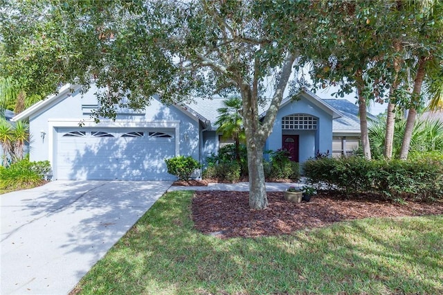 9220 Dayflower Dr, Tampa, FL 33647 - view of front of property with stucco siding, an attached garage, and driveway