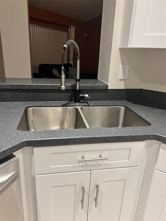 9220 Dayflower Dr, Tampa, FL 33647 - kitchen view of a sink, white cabinetry, and stainless steel dishwasher