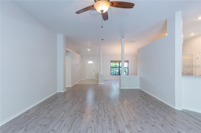 9220 Dayflower Dr, Tampa, FL 33647 - unfurnished living room with wood finished floors, a ceiling fan, baseboards, recessed lighting, and decorative columns