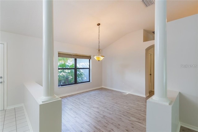 9220 Dayflower Dr, Tampa, FL 33647 - unfurnished room featuring ornate columns, vaulted ceiling, light wood-type flooring, and baseboards