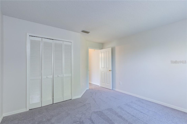 9220 Dayflower Dr, Tampa, FL 33647 - unfurnished bedroom featuring carpet floors, a closet, and baseboards
