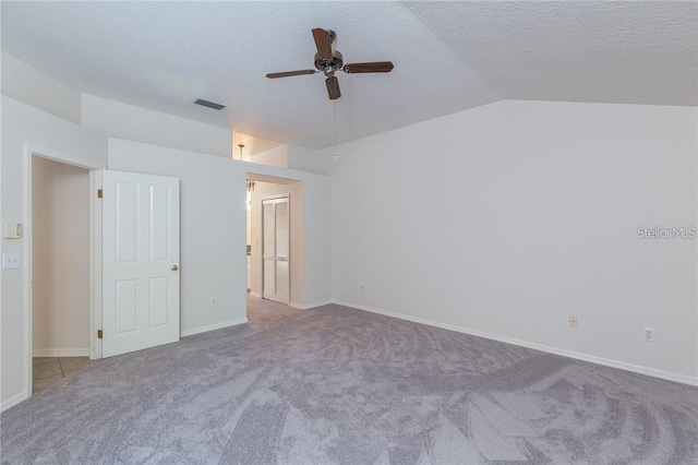 9220 Dayflower Dr, Tampa, FL 33647 - unfurnished room featuring carpet, a ceiling fan, vaulted ceiling, a textured ceiling, and baseboards