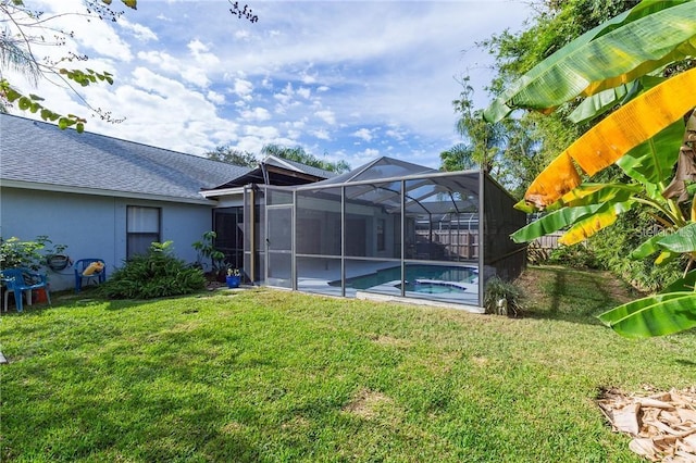 9220 Dayflower Dr, Tampa, FL 33647 - rear view of house featuring a lawn, an outdoor pool, roof with shingles, and stucco siding