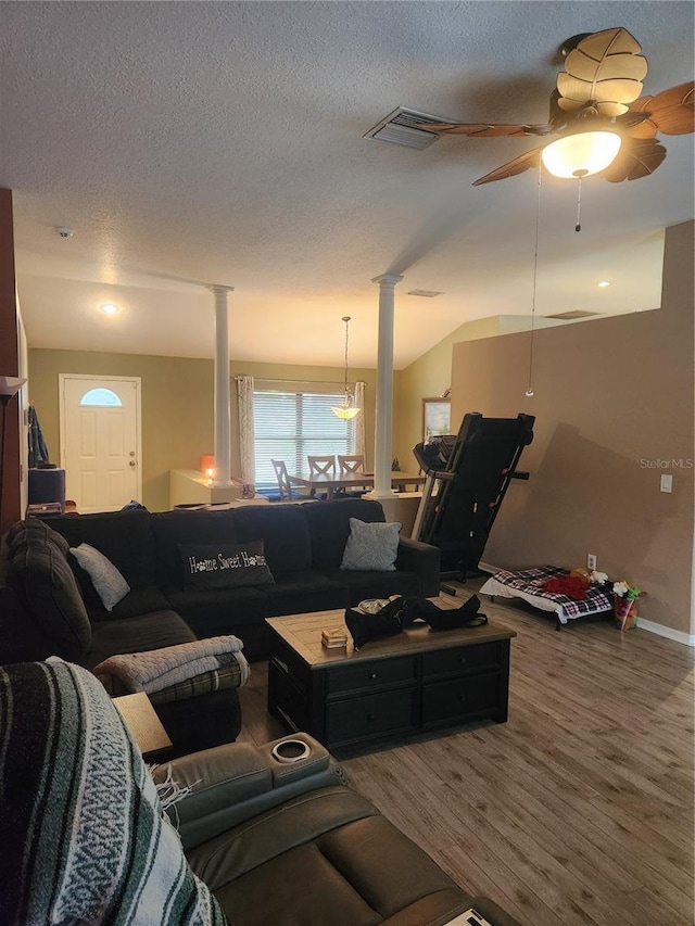 9220 Dayflower Dr, Tampa, FL 33647 - living area with decorative columns, a ceiling fan, a textured ceiling, baseboards, and wood finished floors