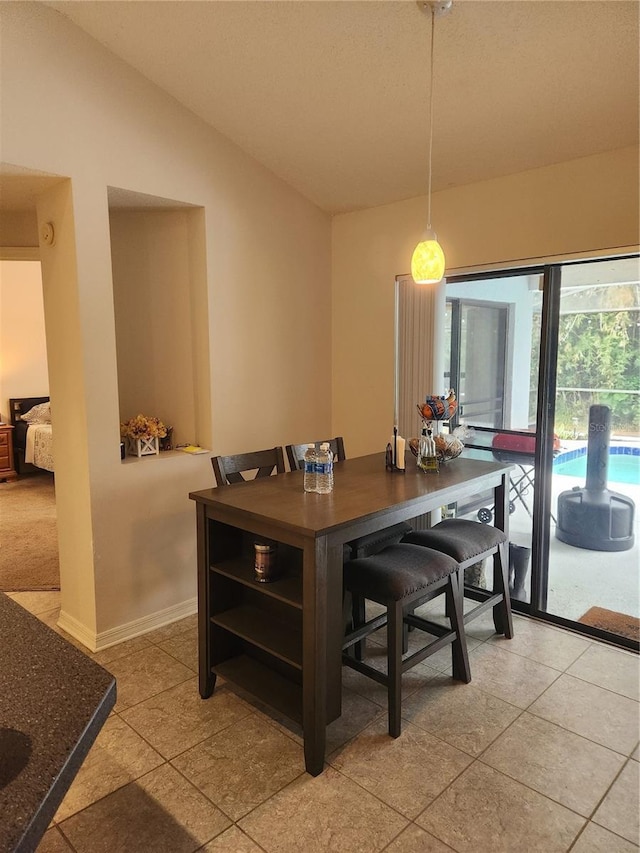 9220 Dayflower Dr, Tampa, FL 33647 - dining space with vaulted ceiling and baseboards