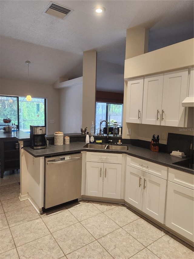 9220 Dayflower Dr, Tampa, FL 33647 - kitchen with stainless steel dishwasher, a sink, a peninsula, white cabinets, and light tile patterned floors