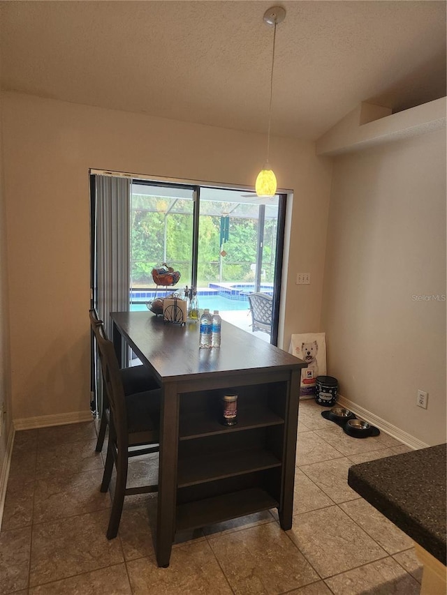 9220 Dayflower Dr, Tampa, FL 33647 - dining area with baseboards, vaulted ceiling, and a textured ceiling