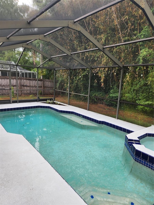 9220 Dayflower Dr, Tampa, FL 33647 - view of pool with a lanai, a pool with connected hot tub, fence, and a patio area