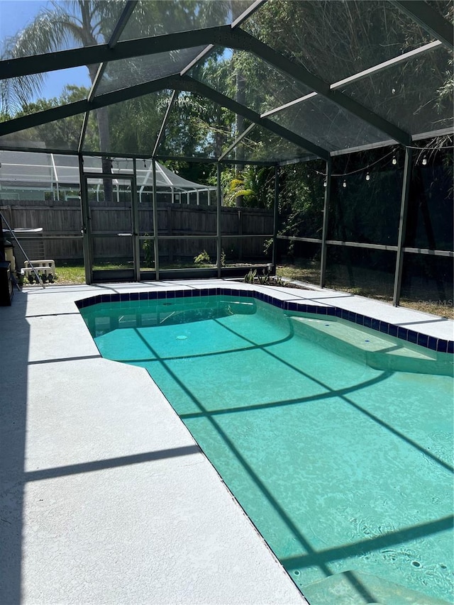 9220 Dayflower Dr, Tampa, FL 33647 - view of swimming pool with a fenced backyard, glass enclosure, and a patio