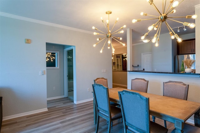 4221 W Spruce St Unit 1303, Tampa, FL 33607 - dining space featuring a chandelier, ornamental molding, wood finished floors, and baseboards