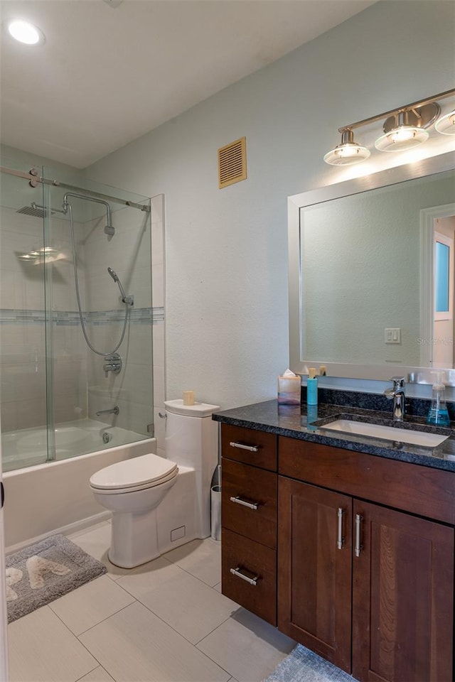 4221 W Spruce St Unit 1303, Tampa, FL 33607 - full bath with enclosed tub / shower combo, tile patterned flooring, vanity, and toilet