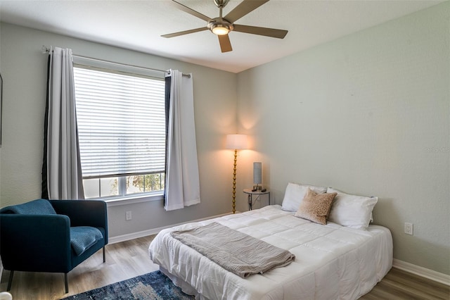4221 W Spruce St Unit 1303, Tampa, FL 33607 - bedroom with wood finished floors, baseboards, and a ceiling fan