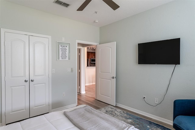 4221 W Spruce St Unit 1303, Tampa, FL 33607 - bedroom with a closet, baseboards, ceiling fan, and wood finished floors