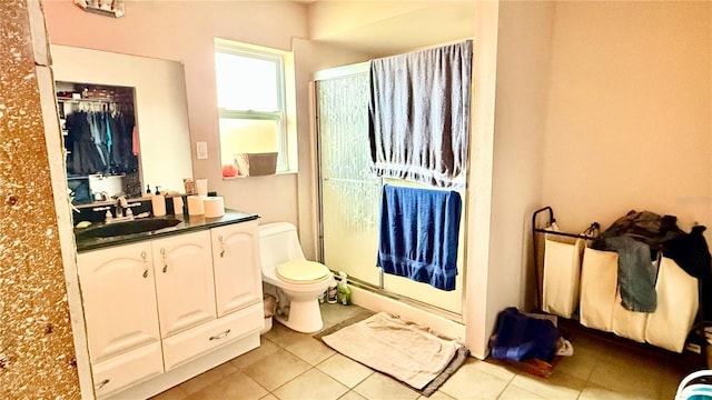 7012 Pin Cherry Ln, Port Richey, FL 34668 - bathroom featuring a stall shower, tile patterned flooring, toilet, and vanity
