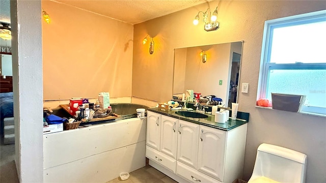 7012 Pin Cherry Ln, Port Richey, FL 34668 - bathroom with healthy amount of natural light, vanity, tile patterned floors, and toilet