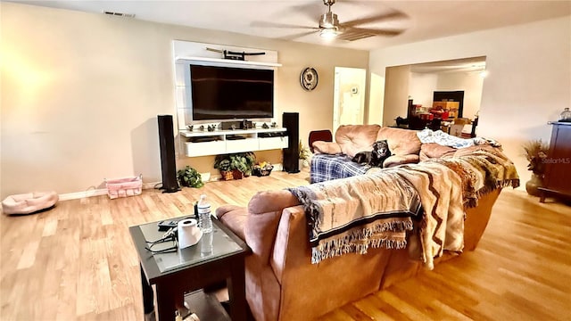 7012 Pin Cherry Ln, Port Richey, FL 34668 - living room featuring a ceiling fan, wood finished floors, and baseboards