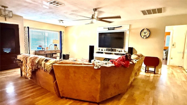 7012 Pin Cherry Ln, Port Richey, FL 34668 - living room with ceiling fan and wood finished floors