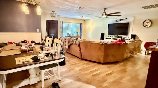 7012 Pin Cherry Ln, Port Richey, FL 34668 - living area featuring ceiling fan and light wood-style flooring